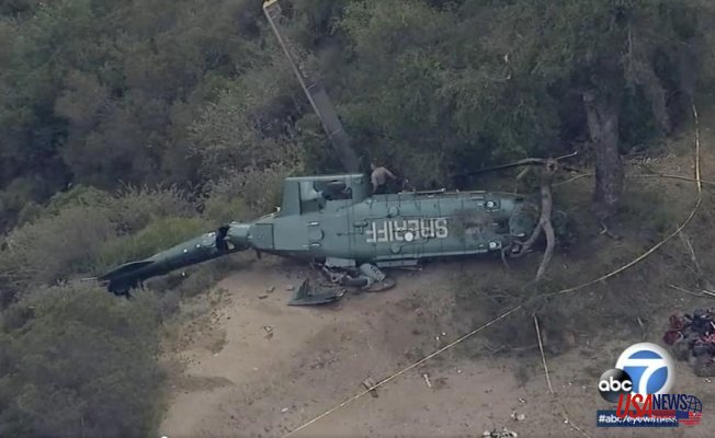 Investigators investigate the crash of a helicopter carrying a LA sheriff
