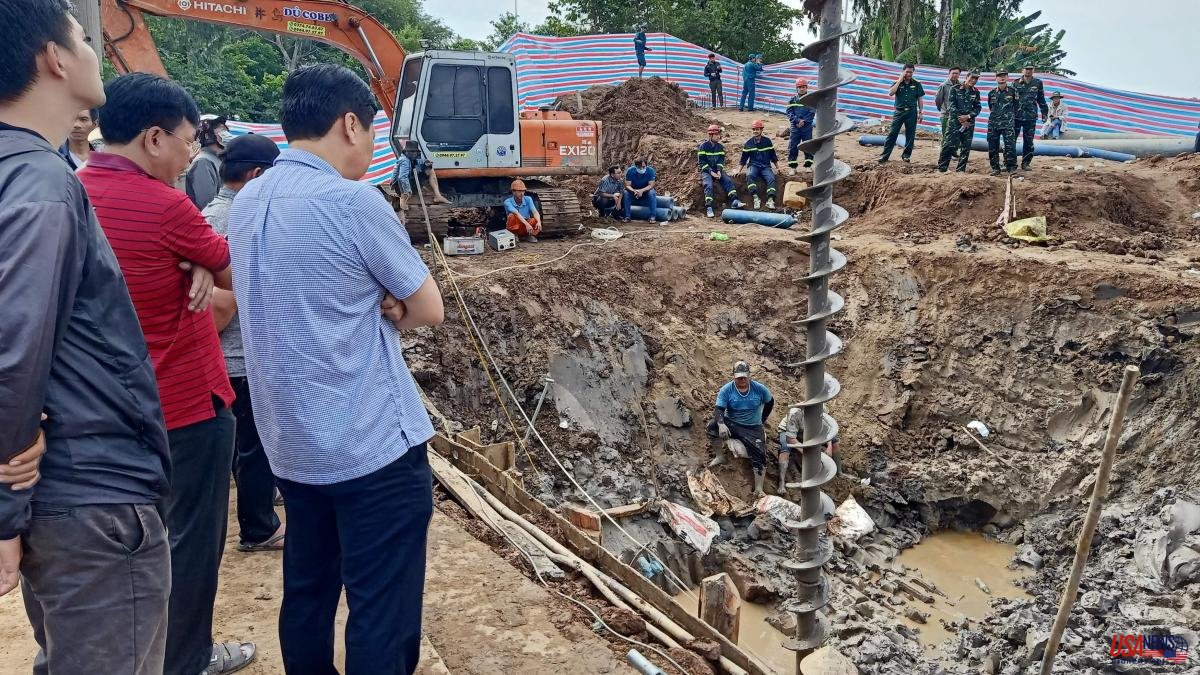 Rescue teams from Vietnam fight to save a boy trapped in a construction zone