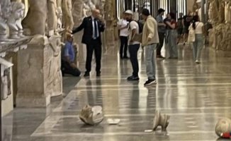 A man knocks down two Roman busts in the Vatican Museums