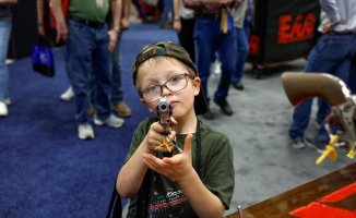 Children holding pistols and rifles: this was the annual meeting of the National Rifle Association