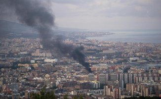 A fire burns a rooftop in the Sant Andreu district of Barcelona