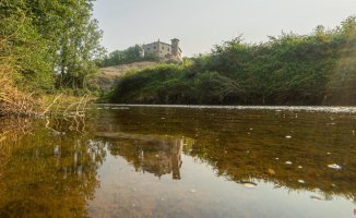 A castle reflected in the Gurri river