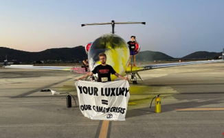 A group of environmentalists spray paint and stick to a private jet at Eivissa airport