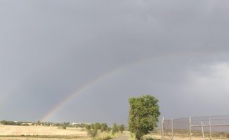 Visual Challenge: What unidentified objects accompany the rainbow in this image?